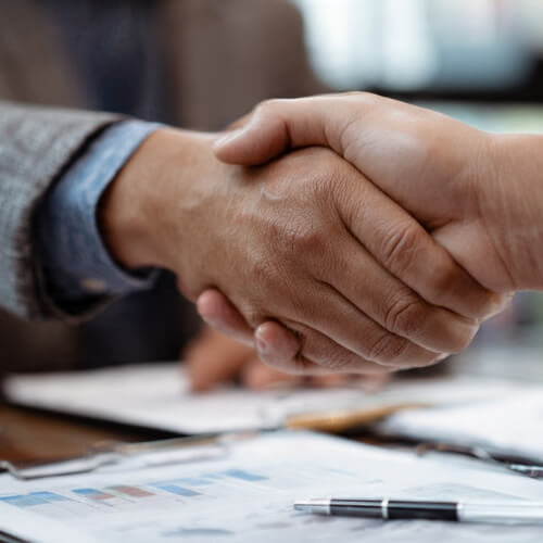 Business partners in Norcross, GA, reviewing partnership tax documents with a consultant