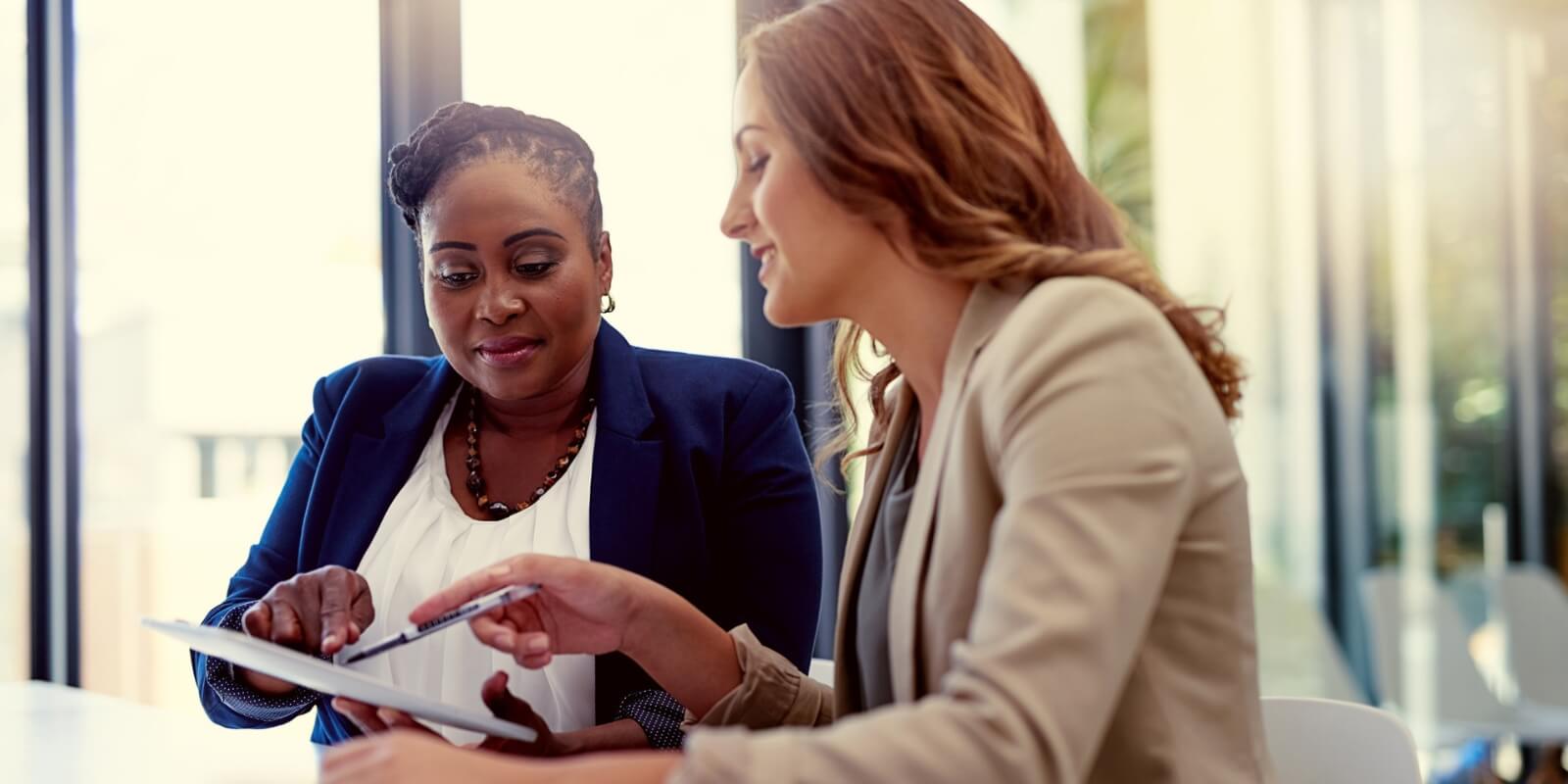 Tax preparer reviewing documents for personal tax preparation with a relaxed client.